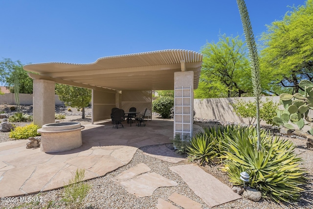 view of patio featuring fence