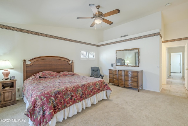 carpeted bedroom featuring lofted ceiling and ceiling fan