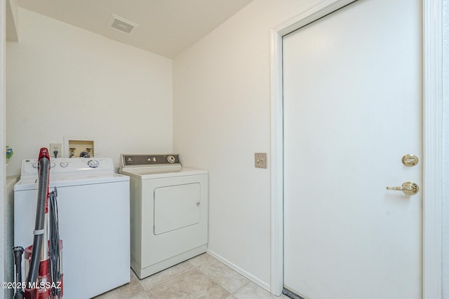 laundry area featuring baseboards, visible vents, independent washer and dryer, laundry area, and light tile patterned floors