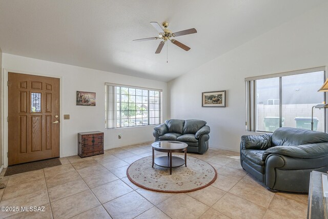 living area featuring high vaulted ceiling, a ceiling fan, baseboards, and light tile patterned floors