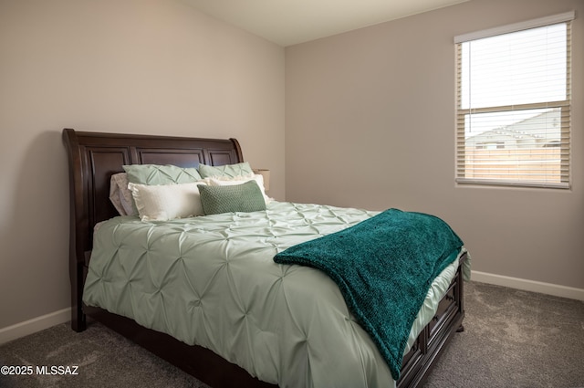 carpeted bedroom featuring baseboards
