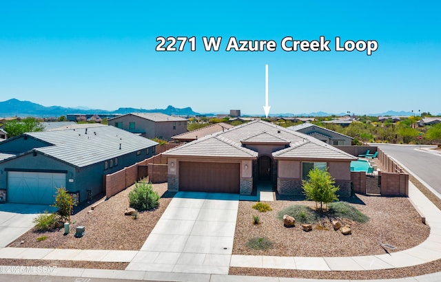 2271 W Azure Creek Loop, Tucson, AZ 85742 - single story home featuring a garage, driveway, fence, and a mountain view