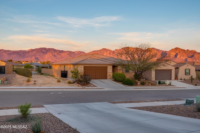 2271 W Azure Creek Loop, Tucson, AZ 85742 - view of front facade featuring a mountain view, a garage, a tile roof, stucco siding, and driveway