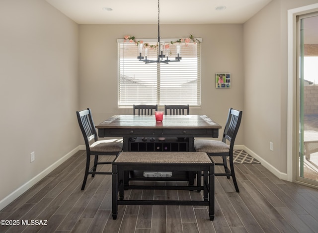 dining room featuring baseboards, a notable chandelier, and dark wood-style floors