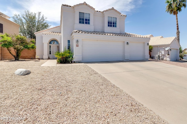 5273 W Fireopal Way, Tucson, AZ 85742 - mediterranean / spanish home with a tile roof, stucco siding, an attached garage, and concrete driveway