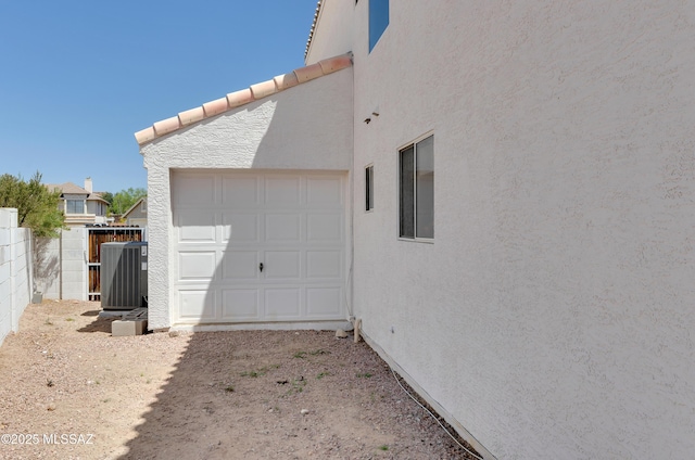 5273 W Fireopal Way, Tucson, AZ 85742 - garage with fence and central AC