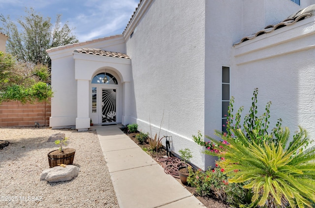 5273 W Fireopal Way, Tucson, AZ 85742 - view of exterior entry featuring stucco siding and a tile roof