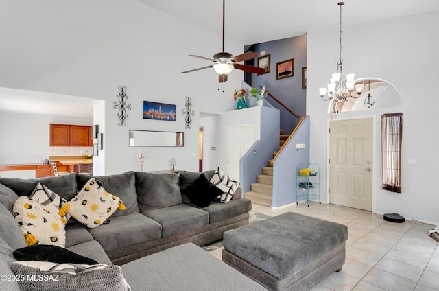 5273 W Fireopal Way, Tucson, AZ 85742 - living area with light tile patterned flooring, ceiling fan with notable chandelier, high vaulted ceiling, and stairway