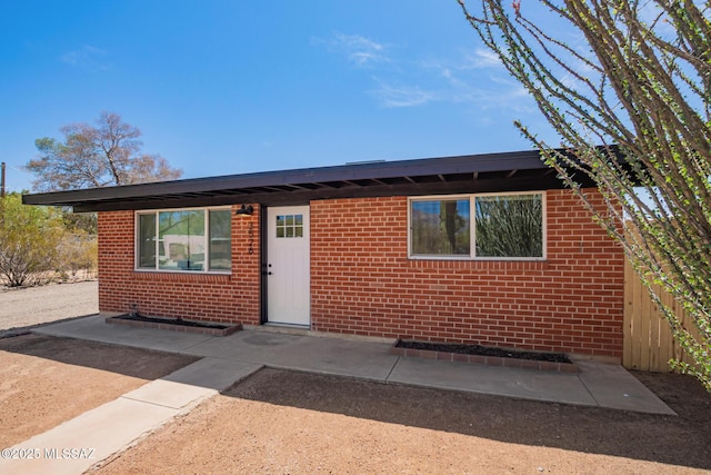 ranch-style home with fence and brick siding