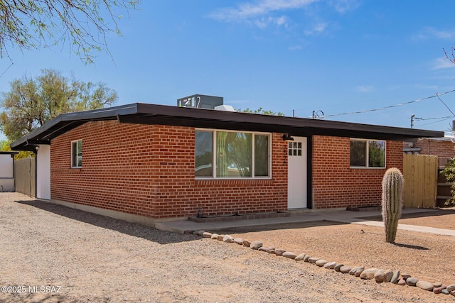 view of front of home with a patio and brick siding