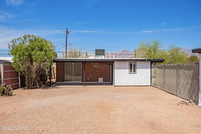 back of property with a fenced backyard, a patio area, and brick siding