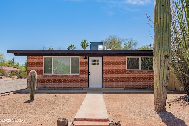 ranch-style home featuring brick siding