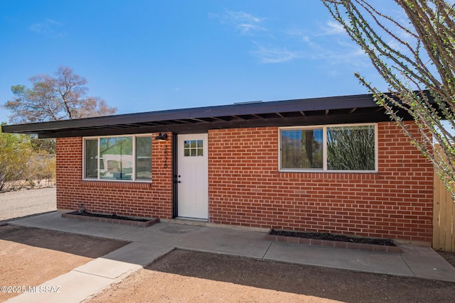 ranch-style house with brick siding