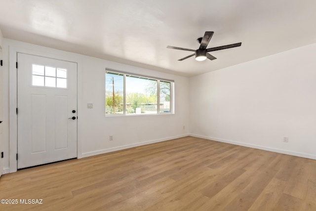 foyer entrance featuring light wood-type flooring, baseboards, and a wealth of natural light