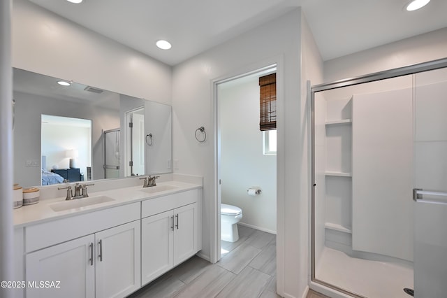 ensuite bathroom with a stall shower, a sink, and connected bathroom