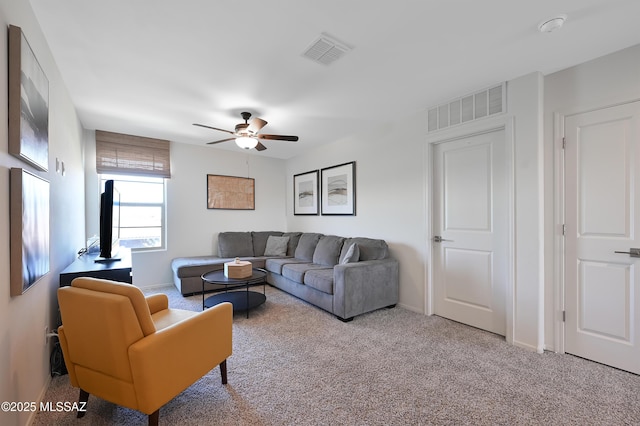 living room with carpet, visible vents, a ceiling fan, and baseboards