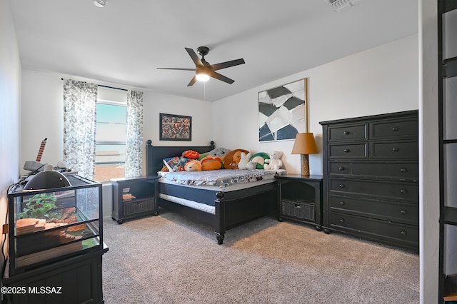 bedroom featuring light colored carpet, ceiling fan, and visible vents