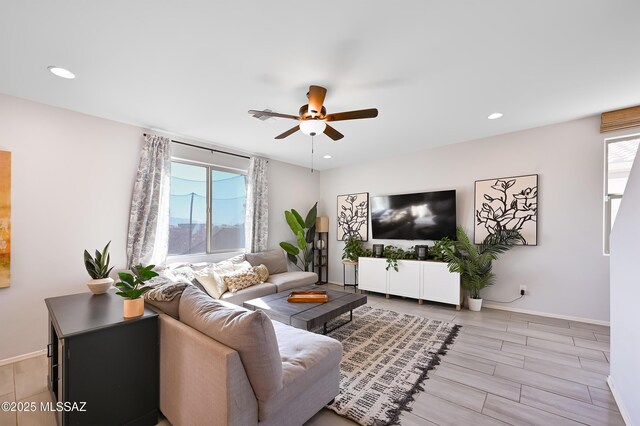 living room with ceiling fan, baseboards, a healthy amount of sunlight, and recessed lighting
