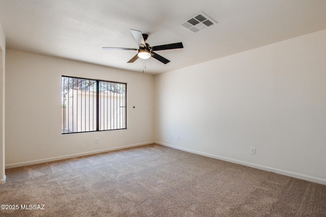 unfurnished room with ceiling fan, carpet, and baseboards