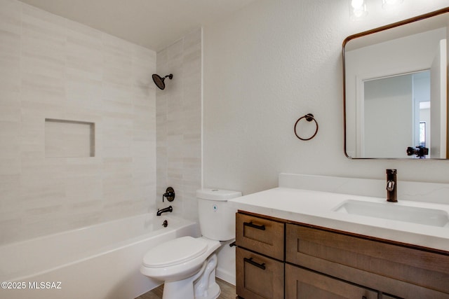 bathroom featuring toilet, vanity, and shower / bath combination