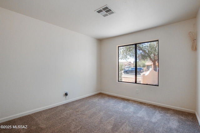 unfurnished room with carpet and baseboards