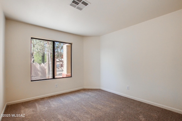 carpeted empty room with baseboards