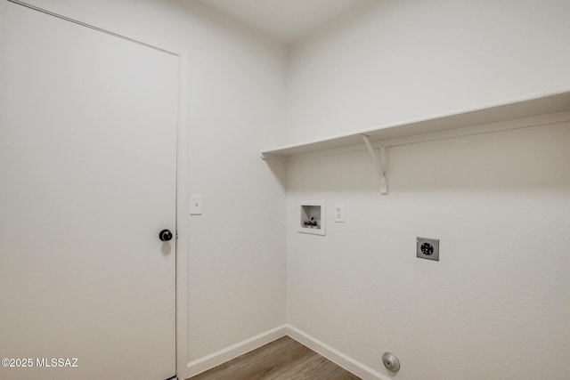 clothes washing area featuring hookup for a washing machine, wood finished floors, baseboards, electric dryer hookup, and gas dryer hookup