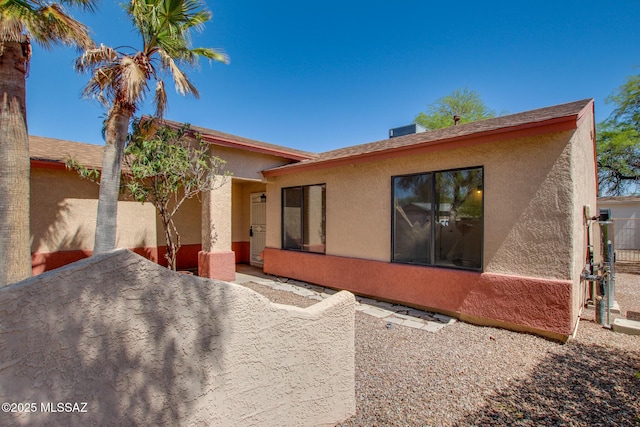 view of front of home featuring stucco siding and a patio area