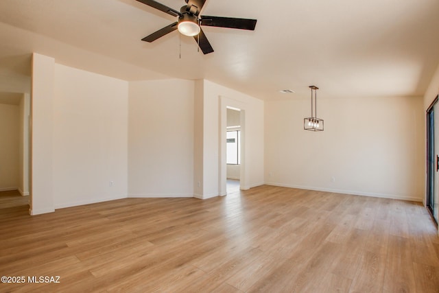 unfurnished room with a ceiling fan, light wood-style floors, and baseboards