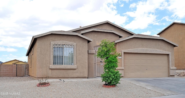 3581 W Avenida Vera Cruz, Tucson, AZ 85746 - view of front of property featuring stucco siding, a garage, driveway, and a gate