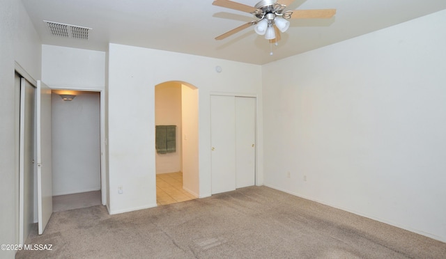 3581 W Avenida Vera Cruz, Tucson, AZ 85746 - unfurnished bedroom featuring arched walkways, carpet, and connected bathroom