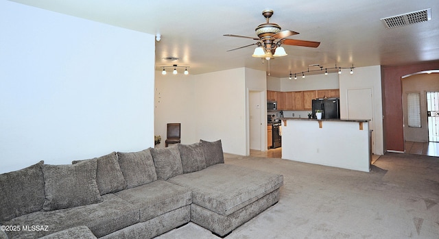 3581 W Avenida Vera Cruz, Tucson, AZ 85746 - living area featuring track lighting, arched walkways, ceiling fan, and light carpet