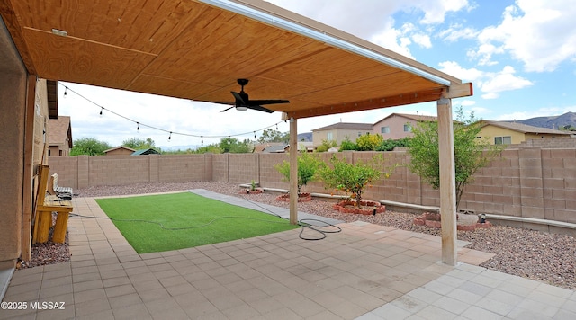 3581 W Avenida Vera Cruz, Tucson, AZ 85746 - fenced backyard with a ceiling fan and a patio area