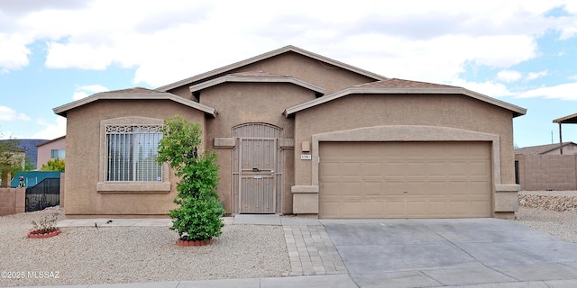 3581 W Avenida Vera Cruz, Tucson, AZ 85746 - view of front of property with stucco siding, a garage, concrete driveway, and a gate