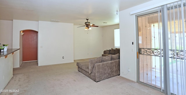 3581 W Avenida Vera Cruz, Tucson, AZ 85746 - living area featuring arched walkways, a ceiling fan, and carpet
