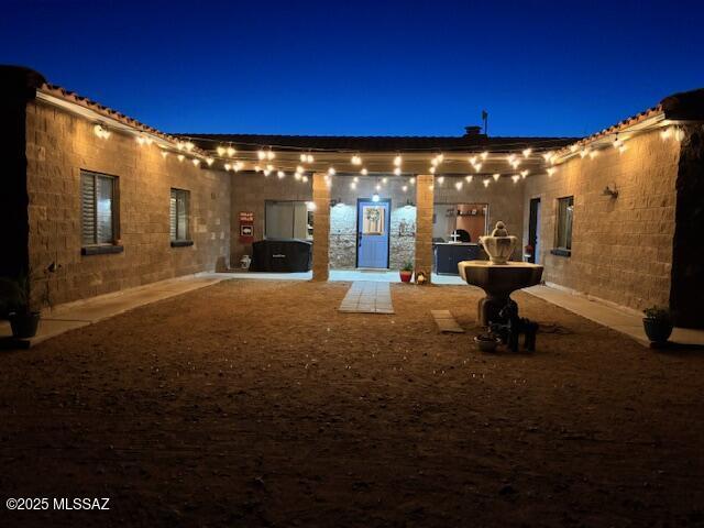 view of back of house at night