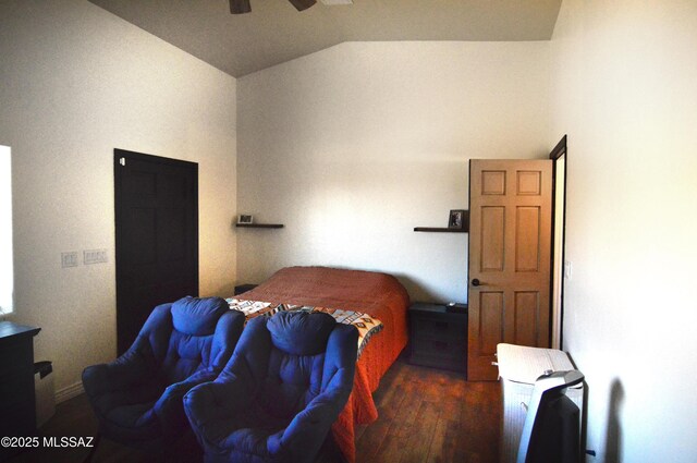 bedroom with a ceiling fan, wood finished floors, and vaulted ceiling