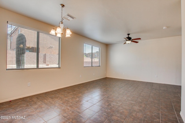 tiled empty room with baseboards, visible vents, and ceiling fan with notable chandelier