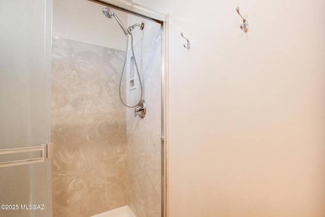 bathroom featuring a shower with shower door