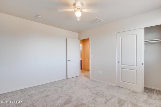 unfurnished bedroom with a ceiling fan, a closet, carpet, baseboards, and visible vents