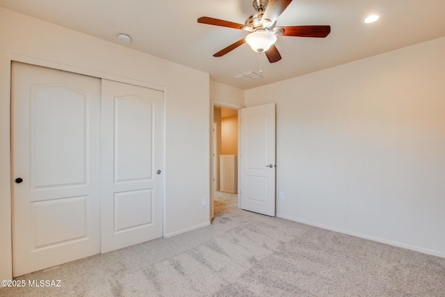 unfurnished bedroom with carpet, visible vents, a ceiling fan, a closet, and baseboards