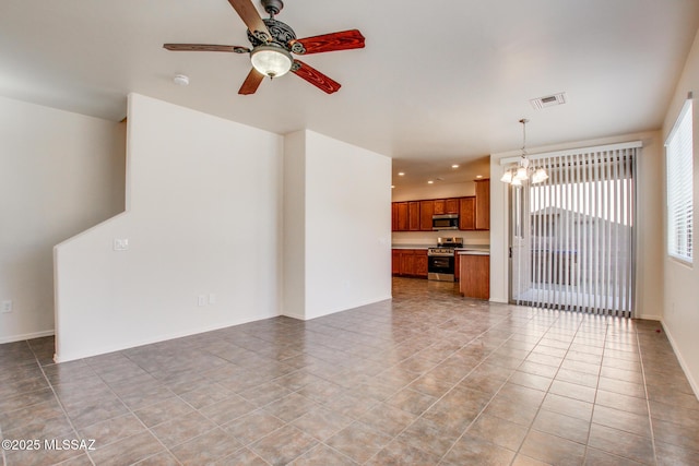 unfurnished living room with ceiling fan with notable chandelier, baseboards, tile patterned flooring, visible vents, and recessed lighting