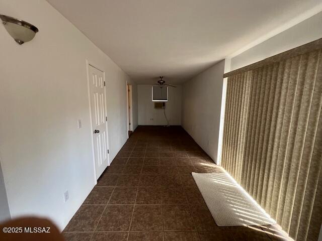 hall with dark tile patterned flooring