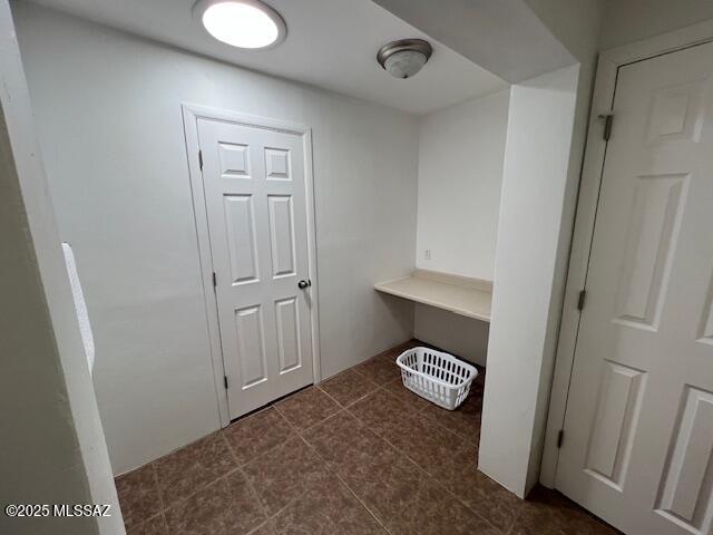 interior space featuring dark tile patterned flooring