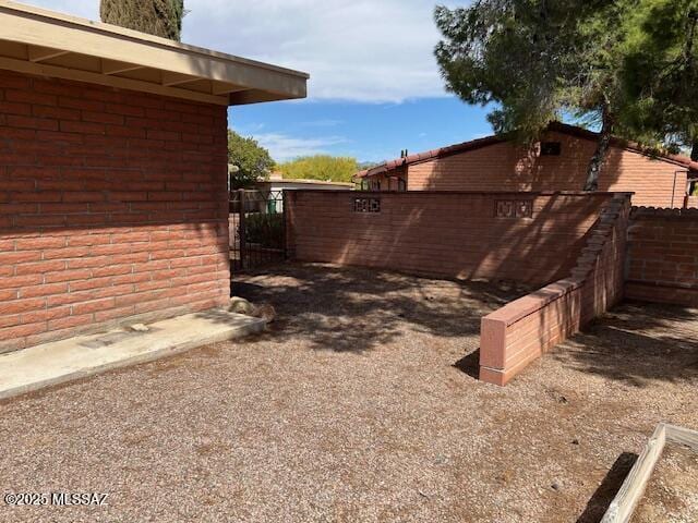 view of yard featuring fence and a gate
