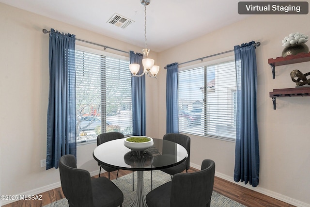dining area featuring an inviting chandelier, visible vents, and plenty of natural light