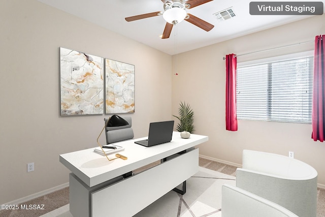 carpeted home office with visible vents, baseboards, and a ceiling fan