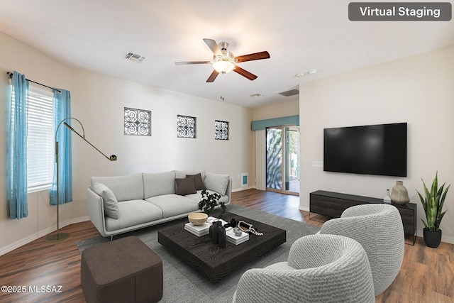 living room featuring visible vents, a ceiling fan, and wood finished floors