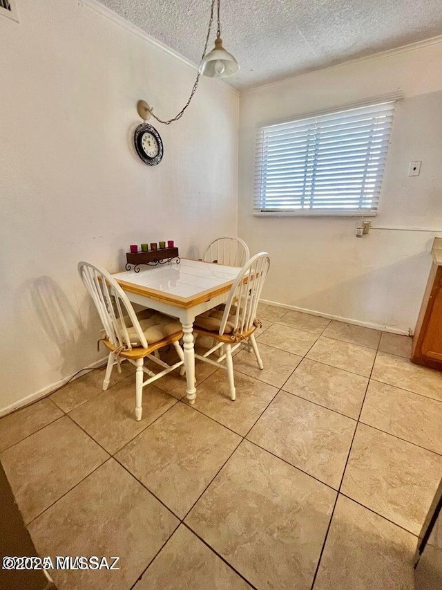 dining space with light tile patterned floors and a textured ceiling