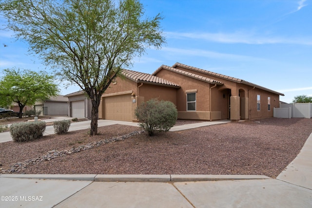 21700 E Governor Dr, Red Rock, AZ 85145 - mediterranean / spanish-style house with a tiled roof, an attached garage, fence, stucco siding, and driveway